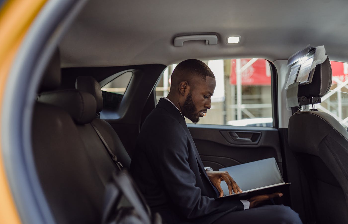 Person reviewing a folder while sitting in a car