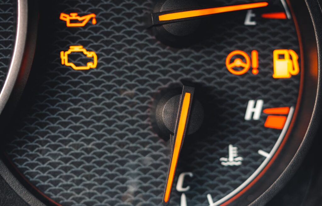 Car dashboard with orange warning symbols illuminated