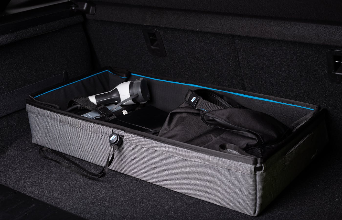 Car trunk organizer holding everyday driving supplies