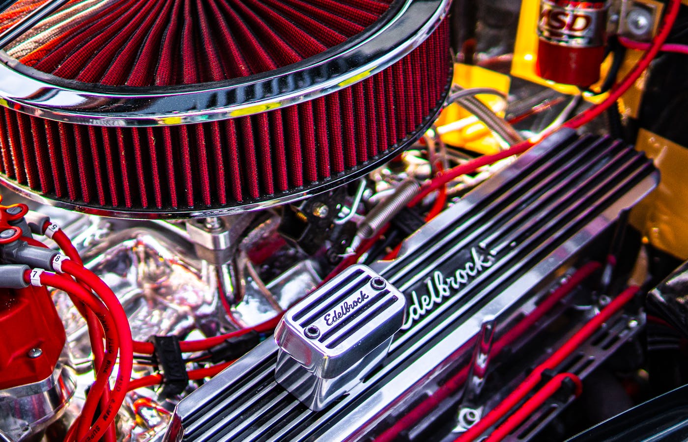 Close-up of a car engine with a red air filter