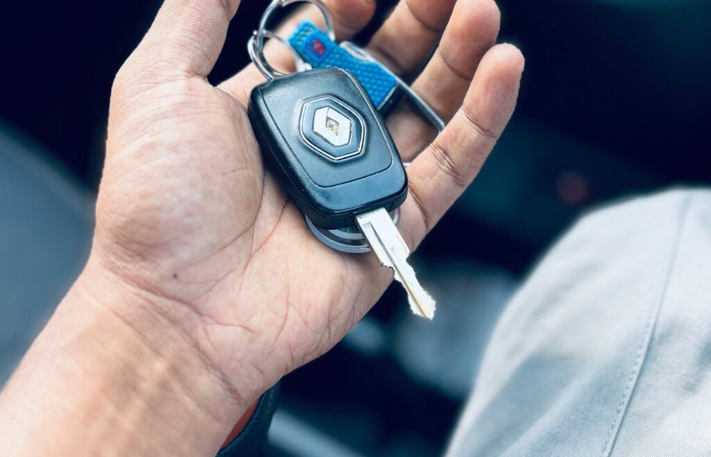 Hand holding a car key inside a vehicle