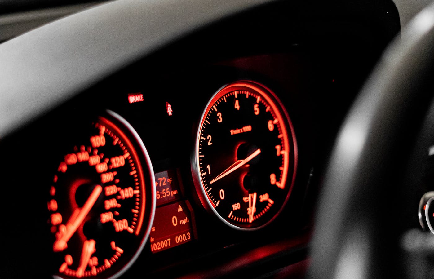 Car dashboard gauges lit in red
