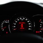 Car dashboard with red warning lights illuminated