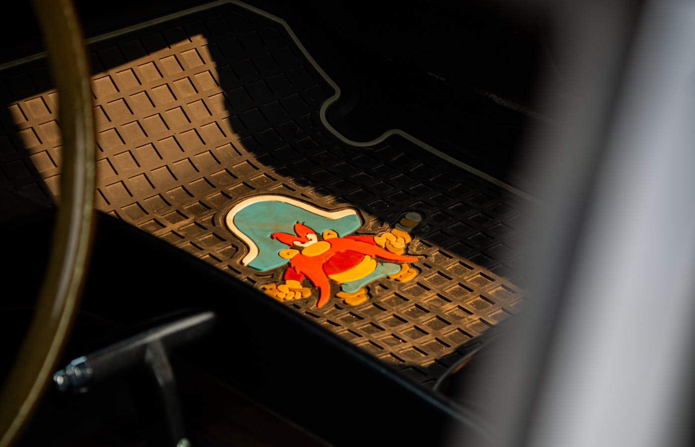 Black rubber car floor mat on the driver side floor