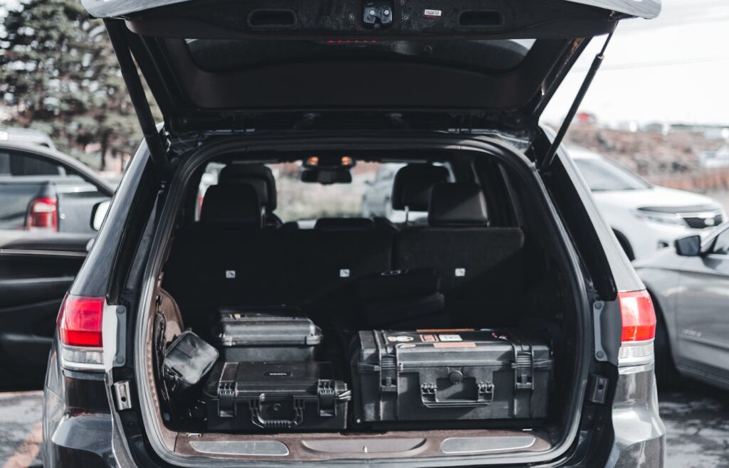 Open car trunk with black storage cases inside