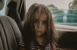 Child sitting in the back seat of a car