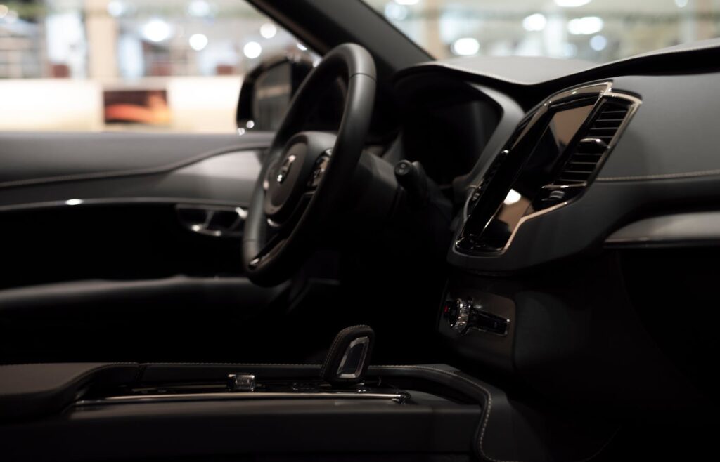 Clean luxury car dashboard with front seats